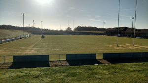 rugby pitch with maintenance machine